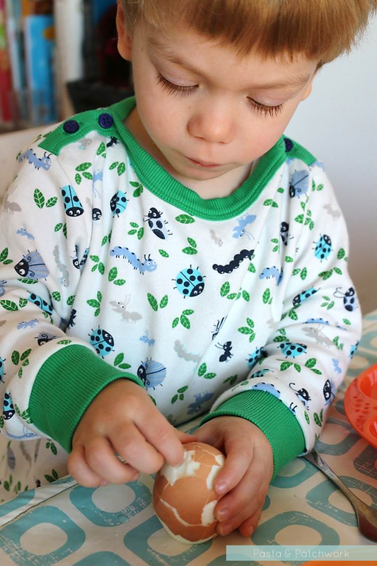 Toddler peeling an egg